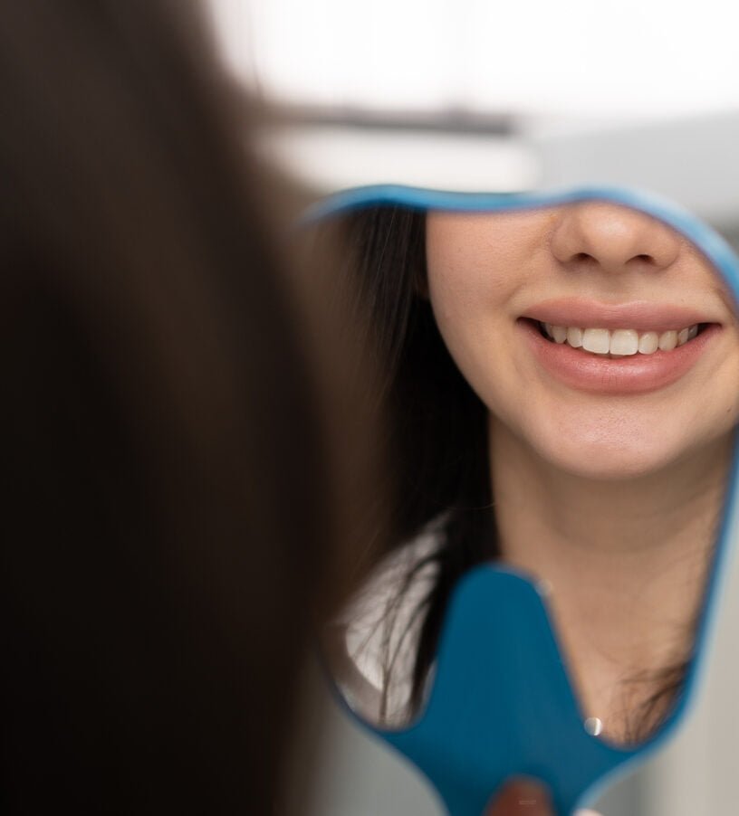 dentistry a satisfied patient looks in the mirror 2023 12 27 15 53 32 utc 1 e1723111301375